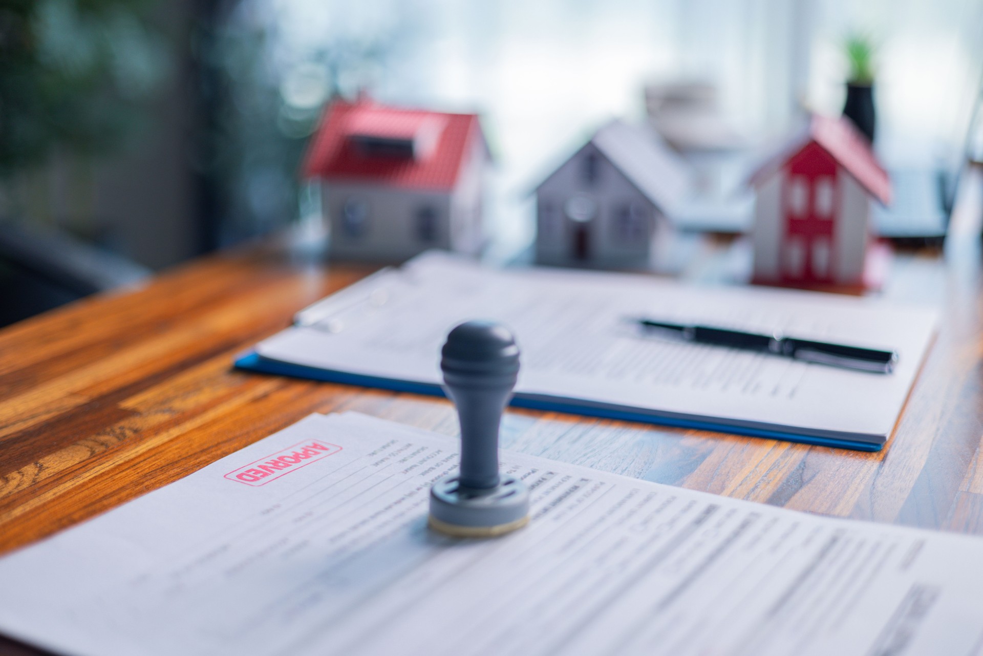 Businessperson decided to buy new home, securing loan to finance property and obtaining insurance for house, with the real estate agent facilitating sale and handing over home key. insurance, estate.